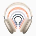 A series of colorful over-ear headphones, including AirPods Max 2, is arranged in a diminishing arc pattern. The headphones at the front are beige, followed by pairs in orange, white, blue, and gray hues, all set against a plain white background.