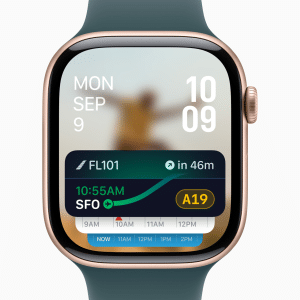 A digital illustration of an Apple Watch displaying the watchOS 26 interface, featuring a modern, translucent menu with rounded buttons and a glass-like aesthetic. The screen shows new watch face options and third-party shortcuts in the Control Center, with a subtle background hinting at health and fitness features like blood pressure monitoring.